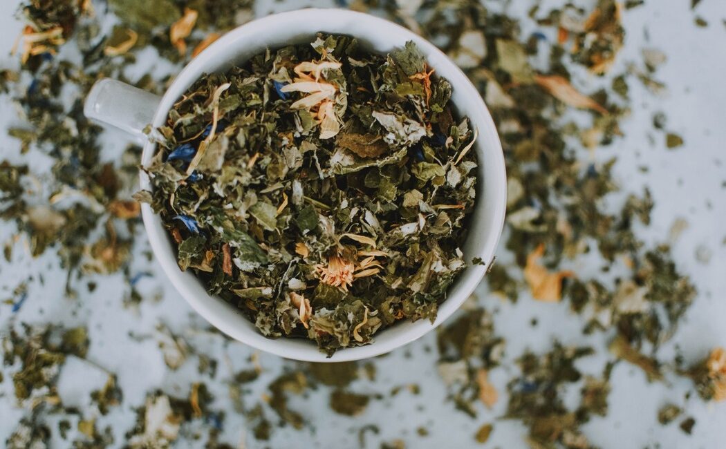 A cup of herbal tea, infused with a delightful blend of aromatic herbs, creating a soothing and refreshing beverage.