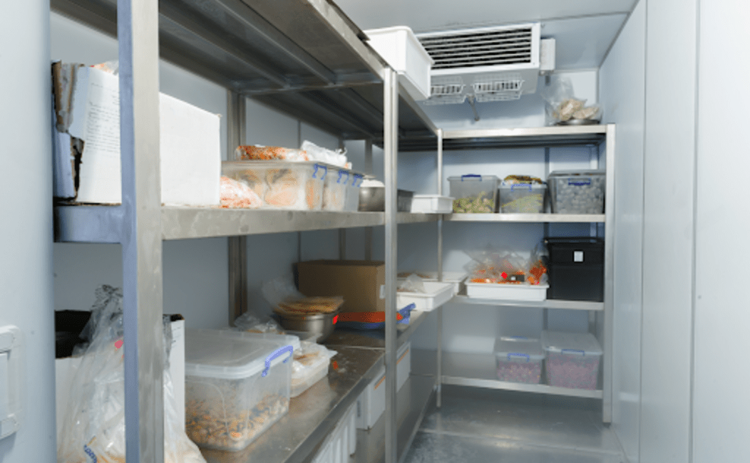 A walk-in freezer filled with various food items and other items.