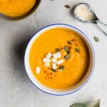 soup in a bowl with seeds on top