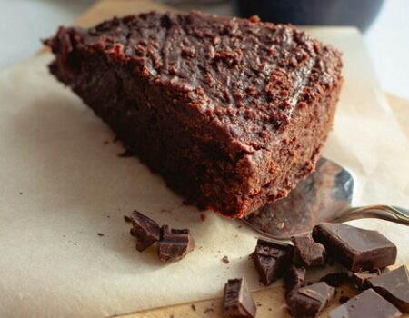 Vegan Chocolate cake with chocolate and on a chopping board